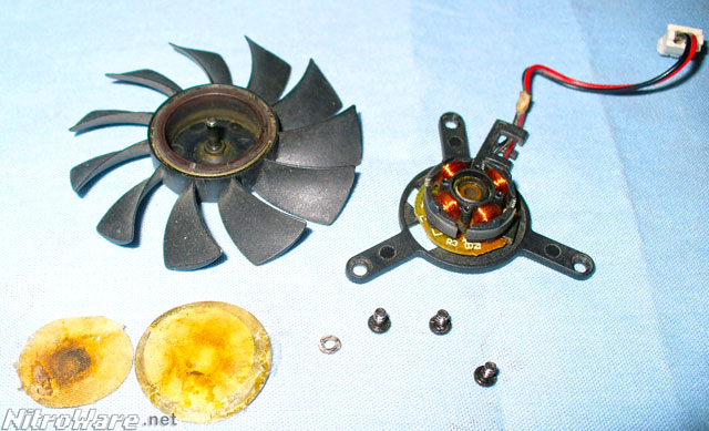 Failed Colourful brand Sleeve bearing fan from a Leadtek 6600GT, Pitting is visible in the bearing and evaporated mineral oil stains the cover sticker and filter